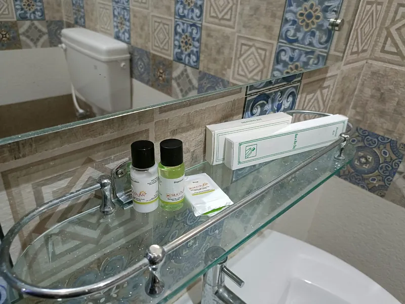 A bathroom vanity with a glass basin and fresh toiletries — Shree Chaitanya Gaudiya Math, Puri