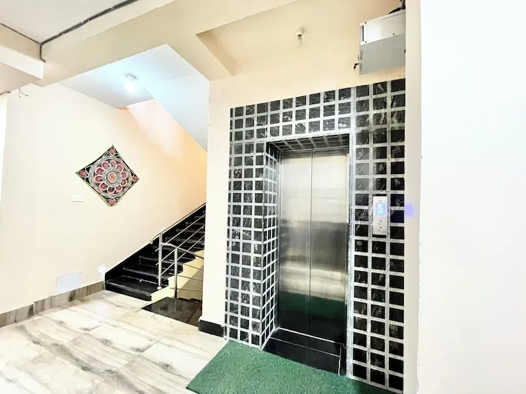 The stairwell and the lift serving the upper floors — Shree Chaitanya Gaudiya Math, Puri