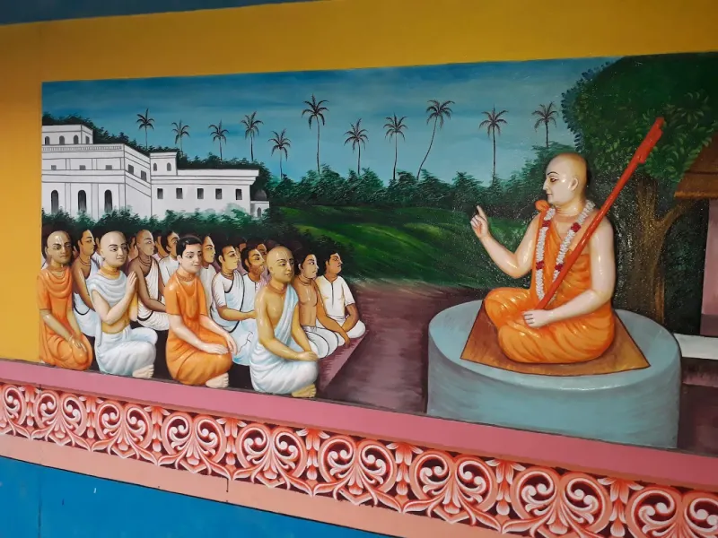 A wall mural of an acharya teaching a gathering of devotees — Shree Chaitanya Gaudiya Math, Puri